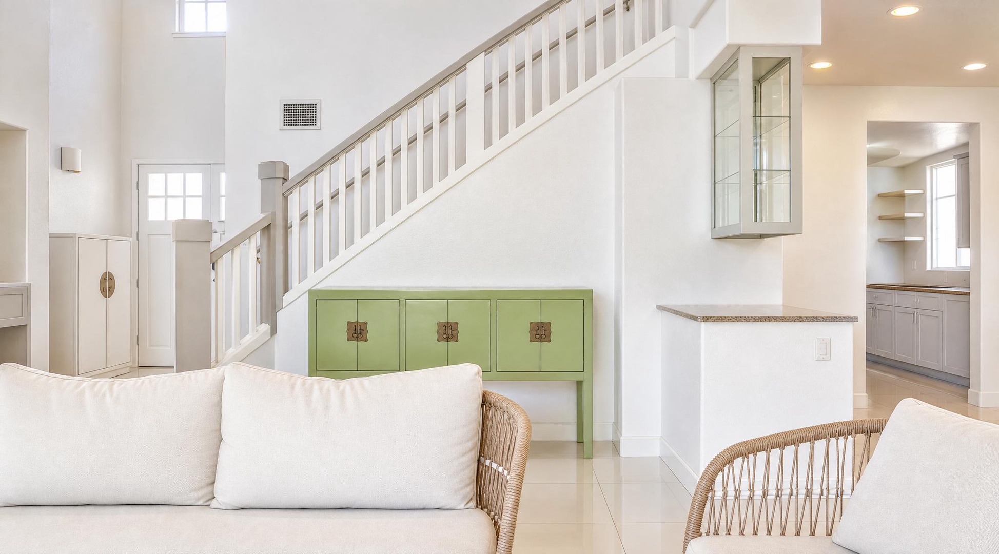 Settle into the sofa below the staircase for a slow afternoon with a book.