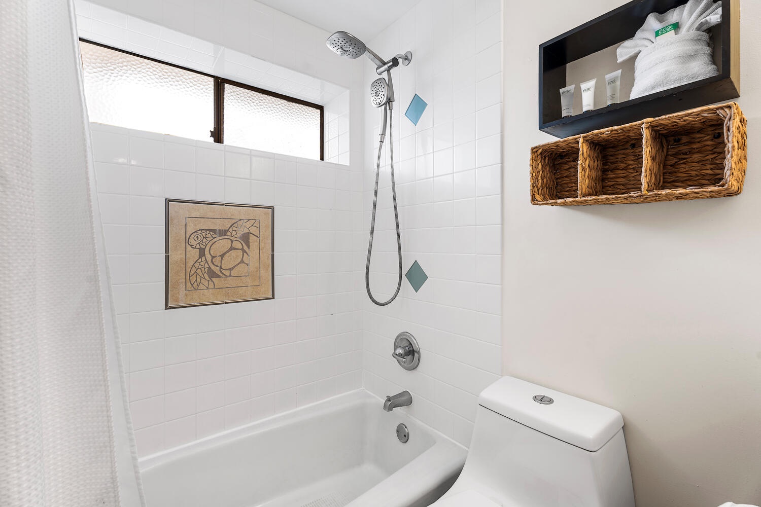 Kailua Kona Vacation Rentals, Kona Plaza 201 - Refresh in your clean, bright bathroom with thoughtful storage touches like wicker baskets and fluffy towels awaiting your arrival.