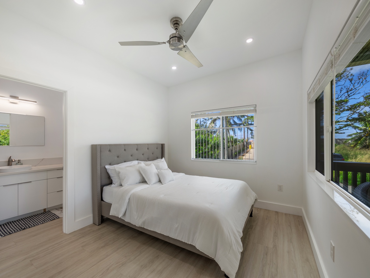 Haleiwa Vacation Rentals, Sunset Beach Island Retreat - This cozy bedroom is designed with comfort in mind, featuring a plush bed with soft linens and a tufted headboard for added elegance.