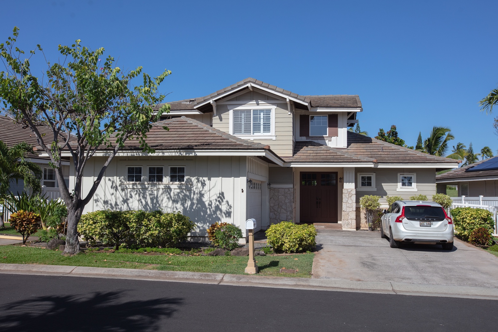 Drive up to a two-story home with a landscaped front yard and room in the driveway.