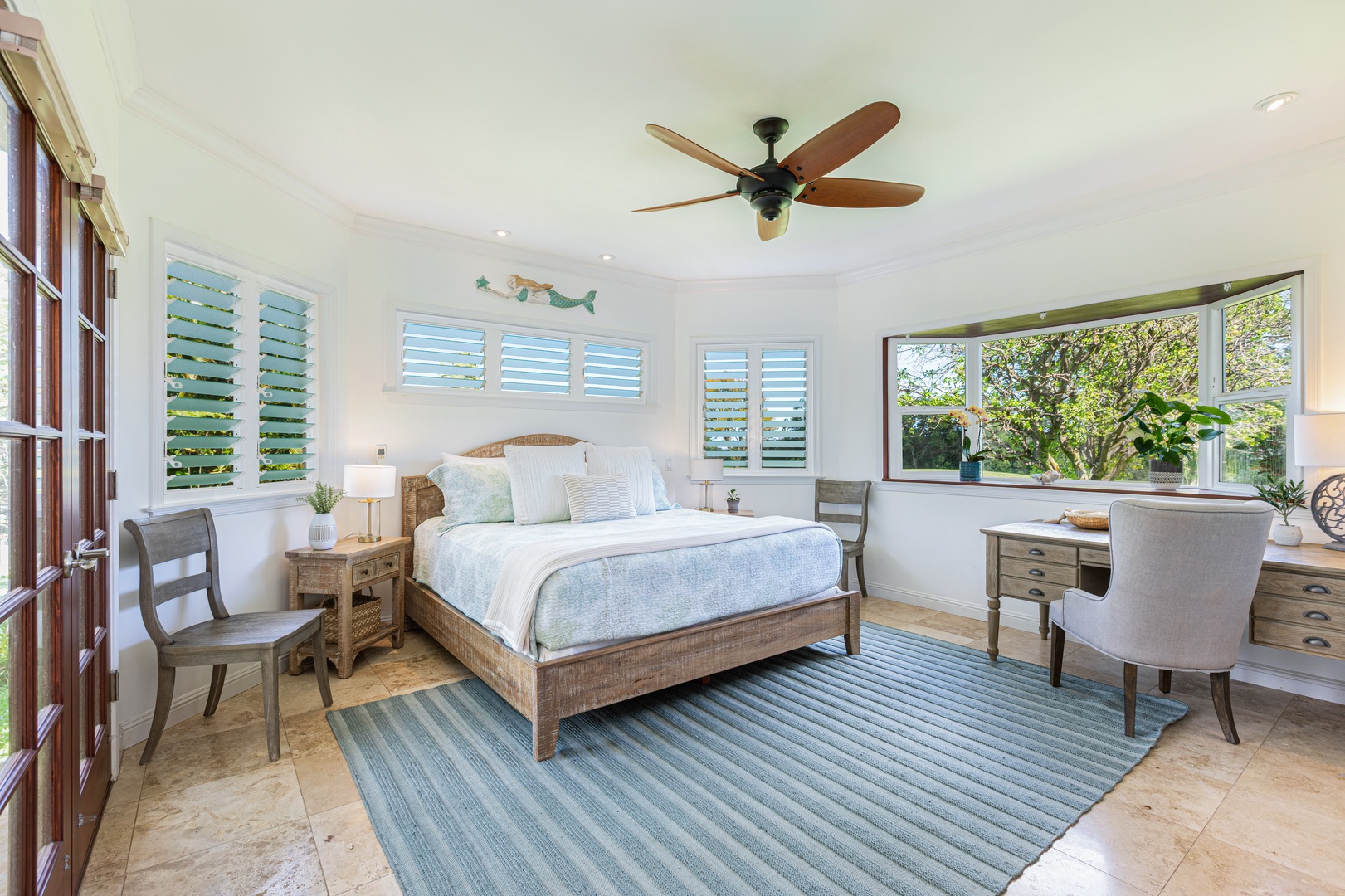 Princeville Vacation Rentals, Ohana Kamalani - Primary bedroom with king bed, ceiling fan, and tranquil golf course views — a peaceful space to unwind.