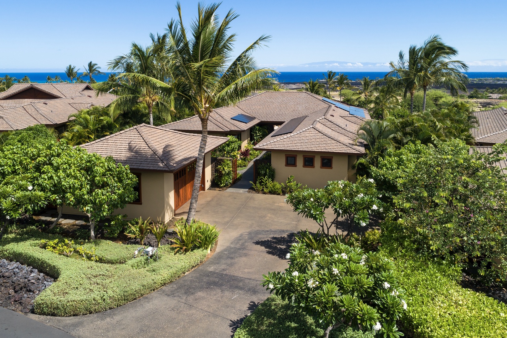 Kailua Kona Vacation Rentals, 4BD Kulanakauhale (3558) Estate Home at Four Seasons Resort at Hualalai - Wide view of exterior entryway showcasing private parking and doors leading to private courtyard entry.