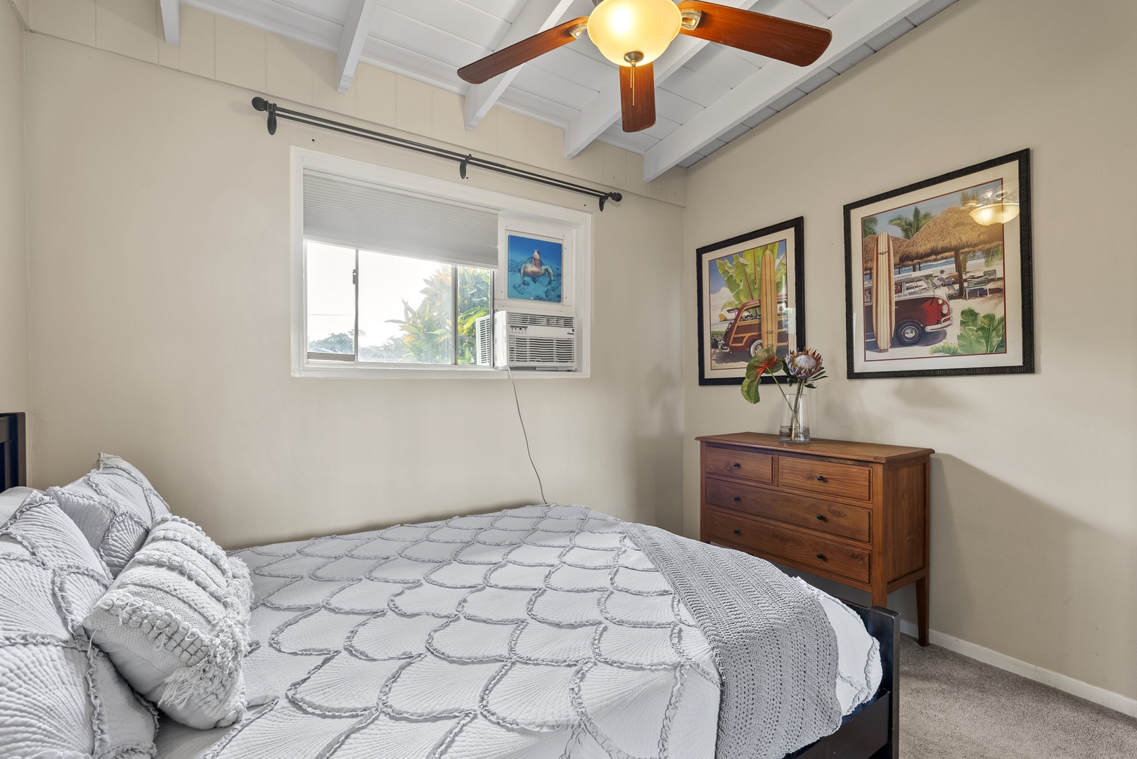 Haleiwa Vacation Rentals, North Shore Beachfront Resort - Queen-size bedroom with vibrant wall art and a dresser.