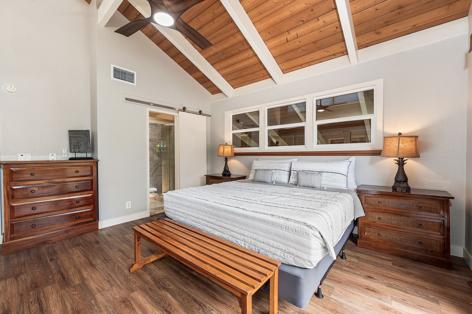 Kailua Kona Vacation Rentals, Kanaloa at Kona 1606 - A king bed under the peak of the ceiling, a sliding barn door alongside.