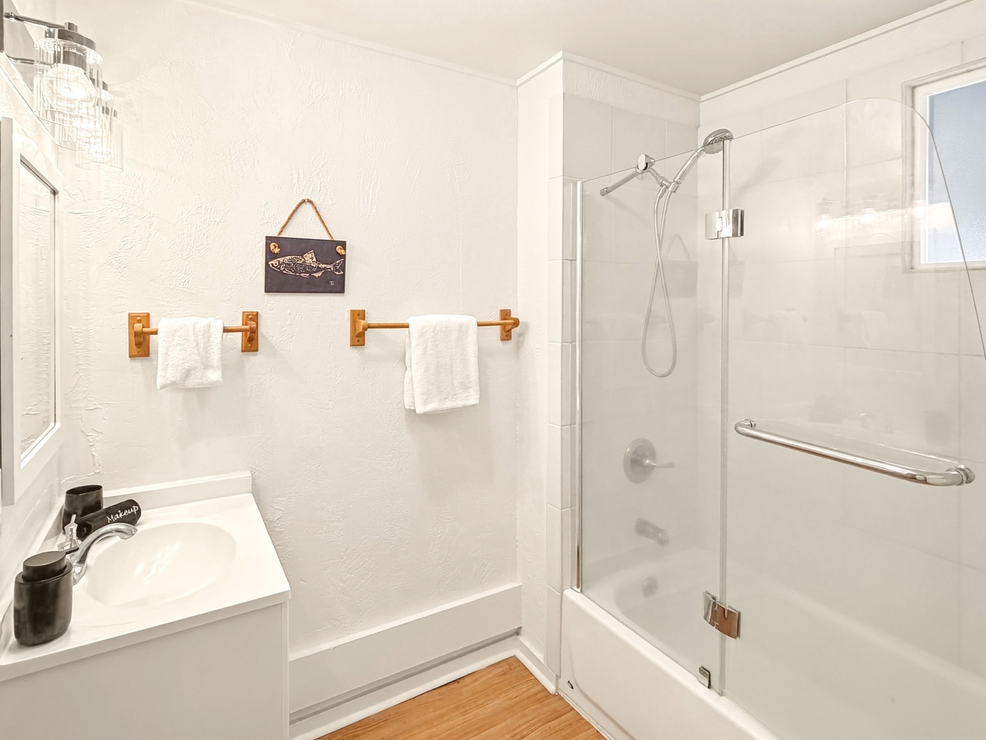 Honolulu Vacation Rentals, Ho'okipa Villa - Refresh in your pristine bathroom featuring a refreshing shower, fluffy towels, and charming nautical touches that create a spa-like retreat.
