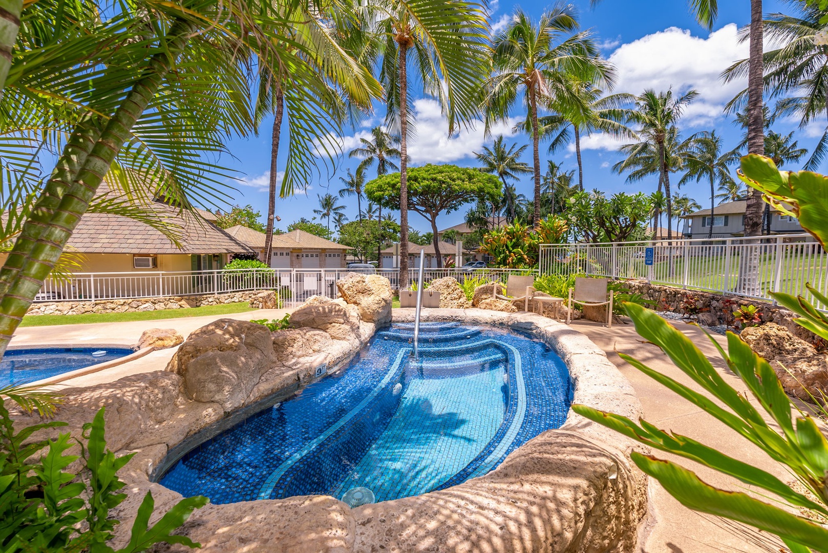 Kapolei Vacation Rentals, Kai Lani Luxury 6D - Poolside jacuzzi with natural rock accents, a serene spot to unwind and enjoy the tropical ambiance.