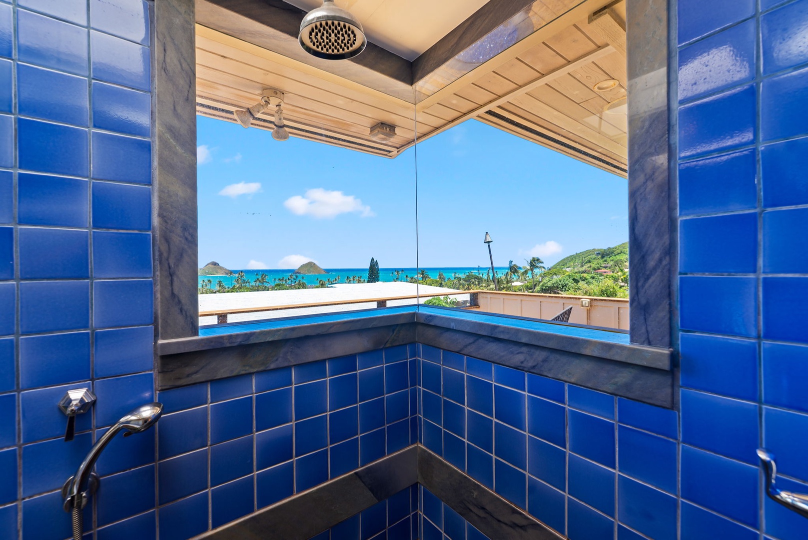 Kailua Vacation Rentals, Leaf House - Rinse off under a rain showerhead while gazing at vibrant blue ocean waters and lush island scenery through your open-air shower's panoramic window.