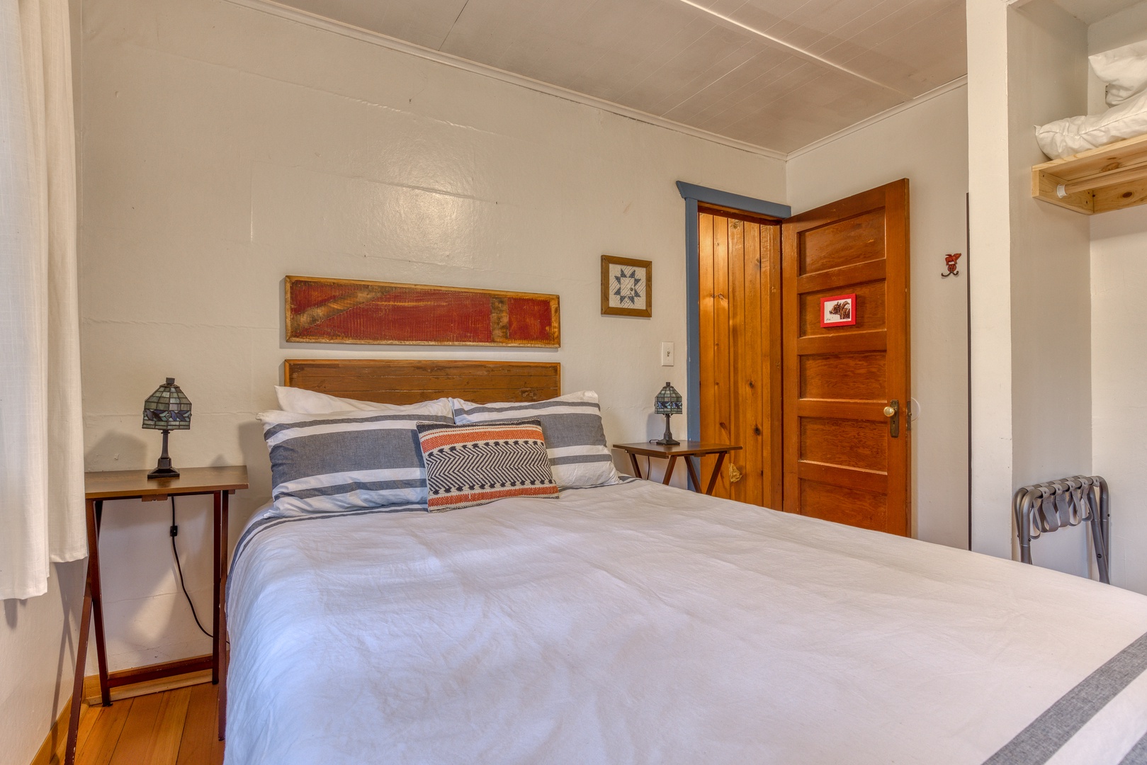 Brightwood Vacation Rentals, Springbrook Cabin - Beautiful primary bedroom with queen bed and view of the forest