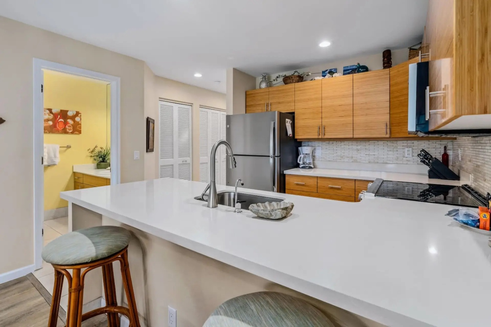 Kihei Vacation Rentals, Maui Kamaole E103 - Grab a quick bite at this counter before heading out the door, bamboo cabinets and stainless appliances all around.