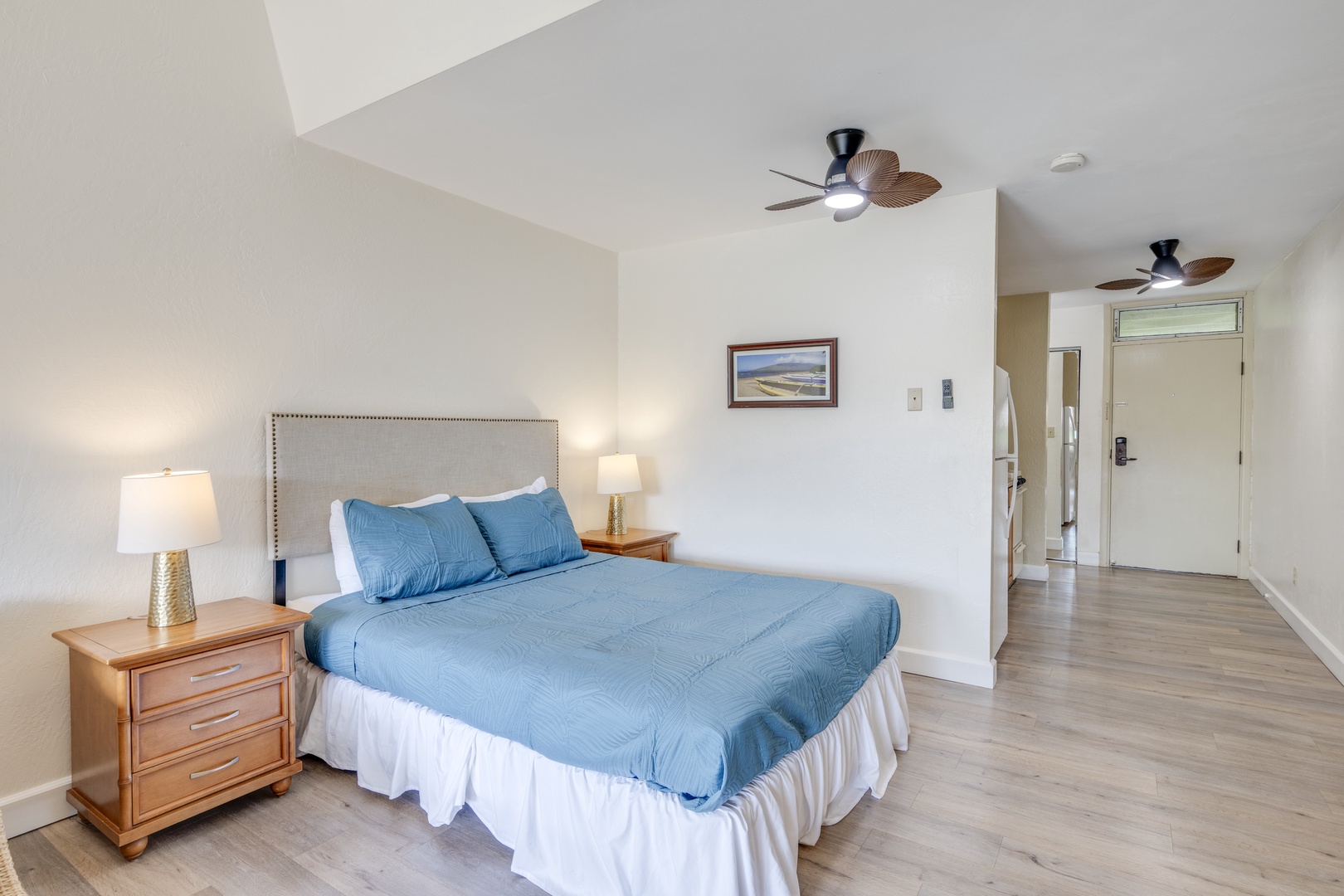 Kihei Vacation Rentals, Kihei Bay Surf B212 - Relax in your peaceful bedroom with crisp blue linens, gentle ceiling fans, and warm wood furnishings creating the perfect coastal retreat.