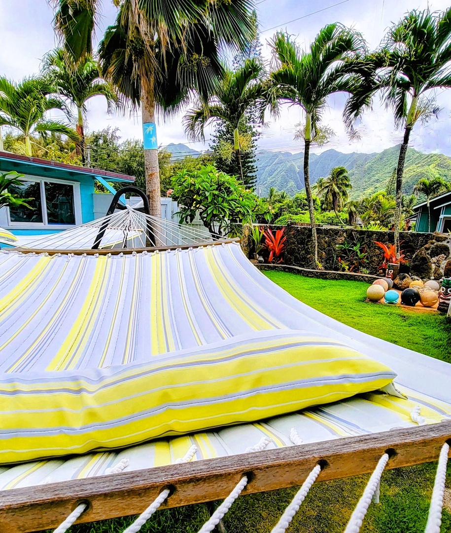 Hauula Vacation Rentals, Private Beach Paradise - A second hammock strung between the palms, the lawn stretching out toward the shore.