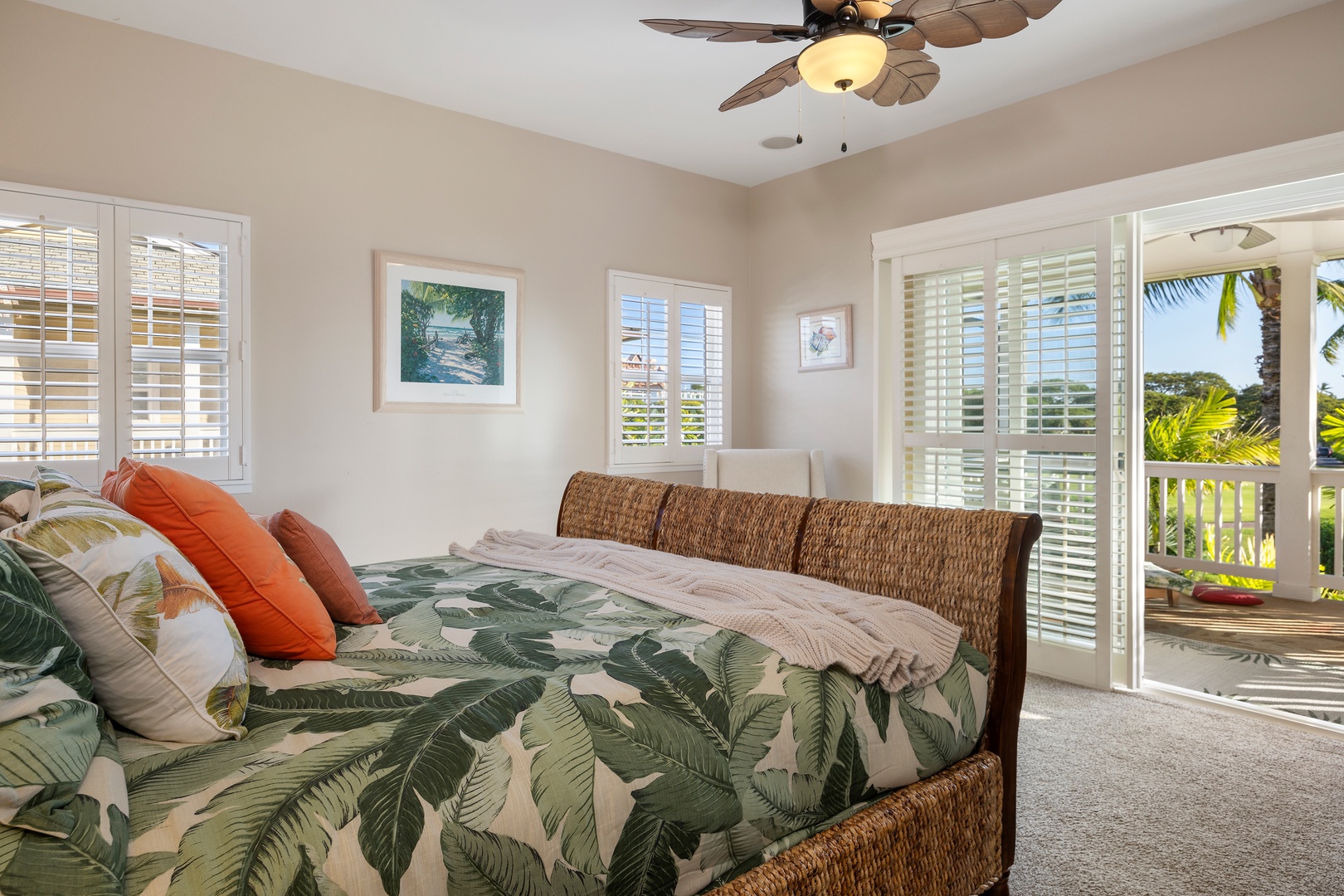 Drift off in your tropical paradise bedroom with palm-print bedding, wicker headboard, and doors opening to your private balcony.