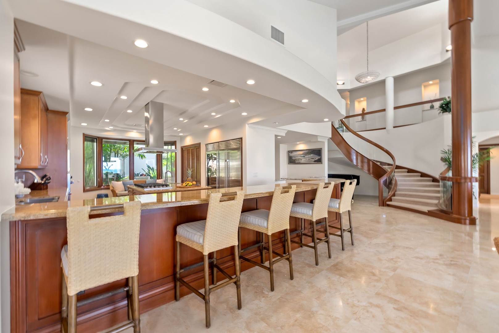 Honolulu Vacation Rentals, Maunalua Estate - A striking spiral staircase anchors this bright interior designed for relaxed gatherings and easy conversation.