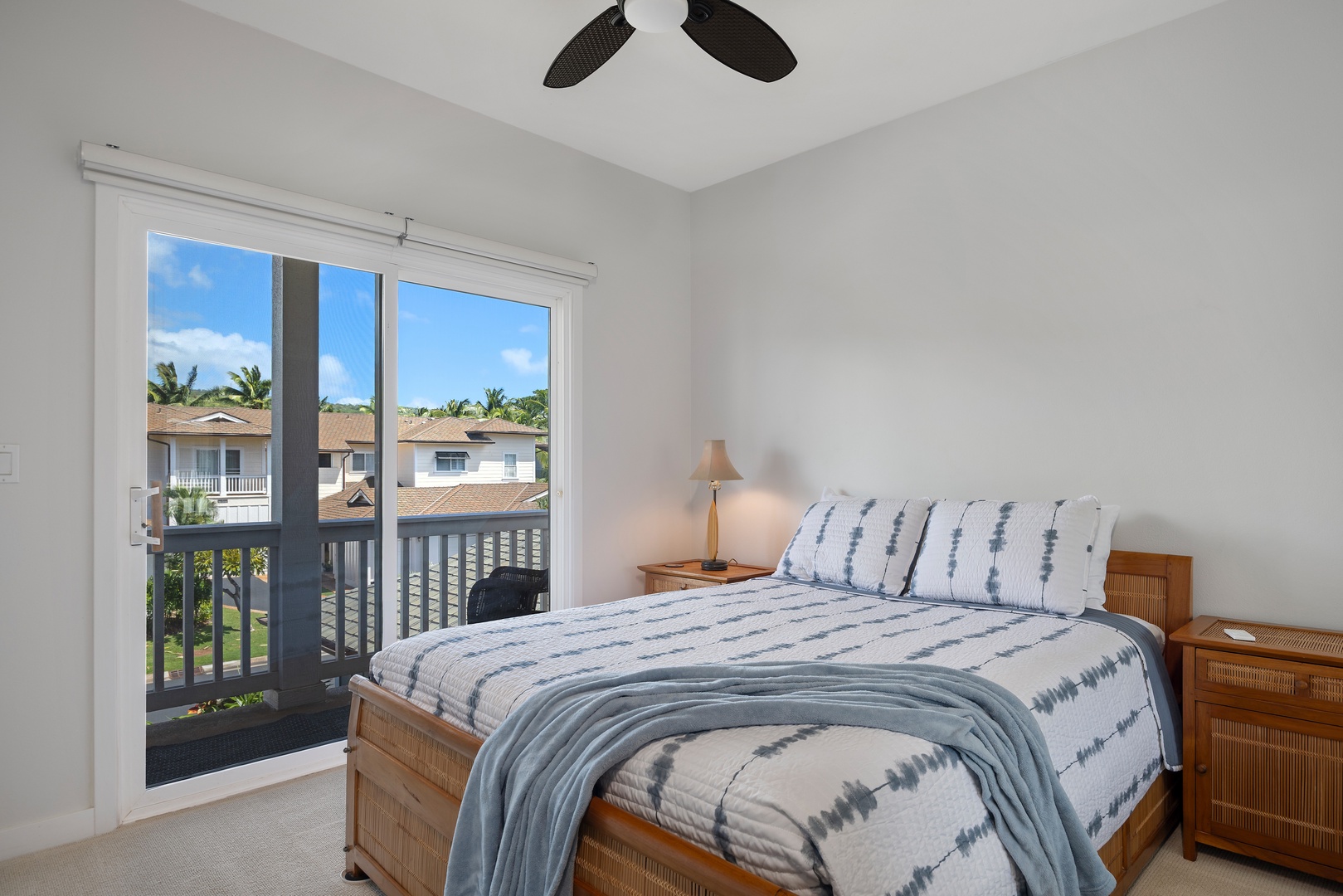 Wake up to gentle breezes from your ceiling fan and tropical views from your private lanai in this peaceful bedroom retreat.