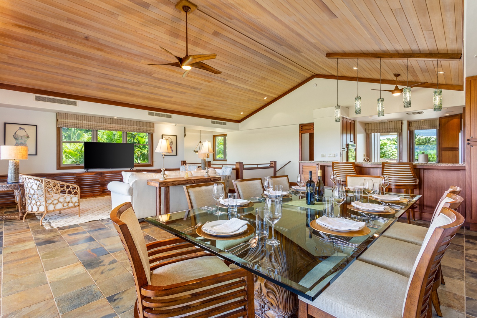 Kailua Kona Vacation Rentals, OFB 3BD Ka'Ulu Villa (129D) at Four Seasons Resort at Hualalai - View of dining table toward the modern kitchen with bar seating.