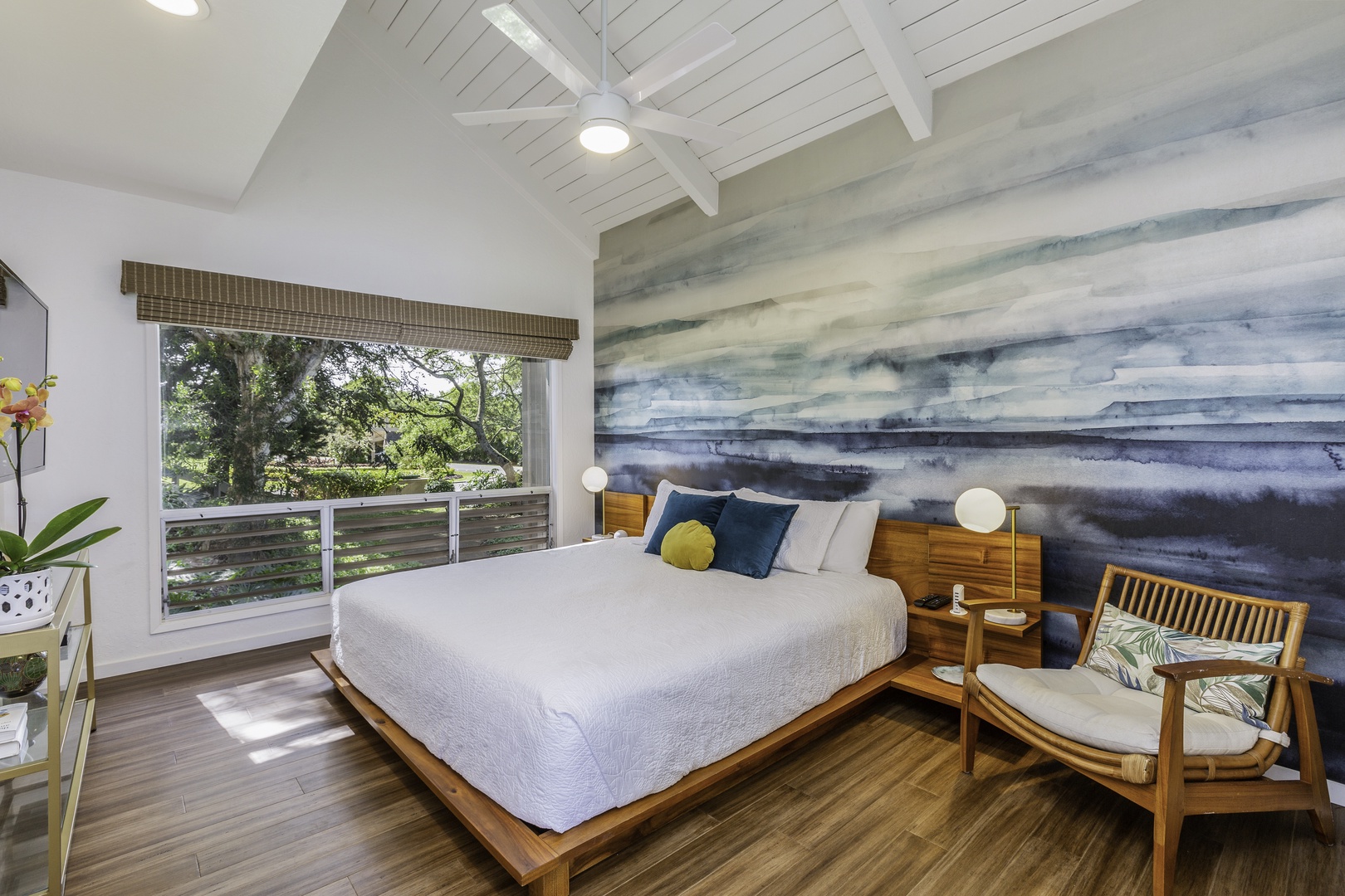 Princeville Vacation Rentals, Pali Ke Kua 207 - In the primary bedroom, linger in your brand new King-size bed as you enjoy the charming garden views outside the picture window, as well as the natural light enhanced by the room’s vaulted ceilings.