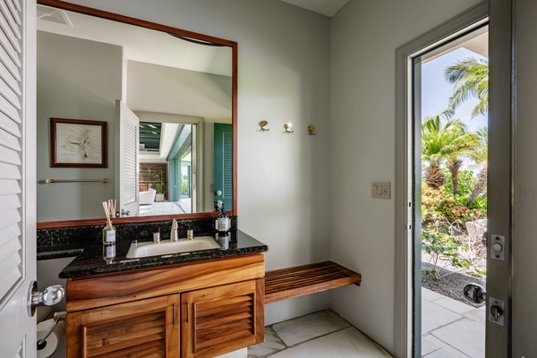 Kamuela Vacation Rentals, Champion Ridge 22 & 24 - Small bathroom with a wooden vanity and easy outdoor access, perfect for quick freshen-ups.