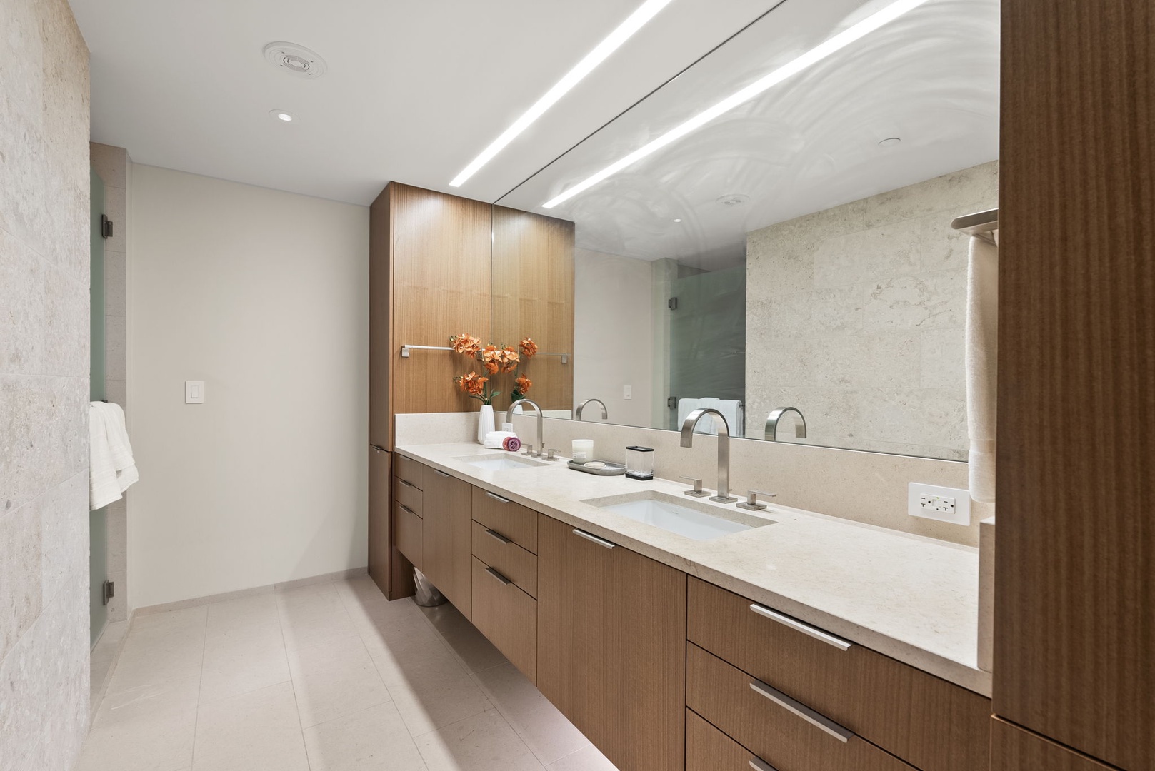 Honolulu Vacation Rentals, Park Lane Getaway - Modern primary bathroom with a sleek double vanity and plenty of counter space for your essentials.