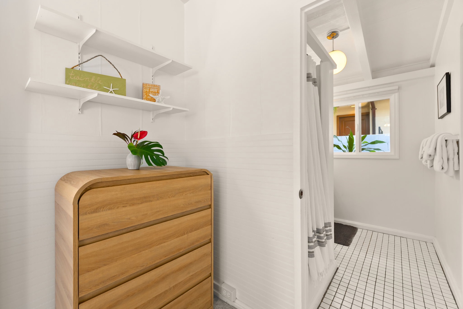 Honolulu Vacation Rentals, Ho'okipa Villa - A modern, minimalist space features stylish wood storage and bright, clean lines. Your private bathroom awaits with crisp white tile flooring and thoughtful touches.