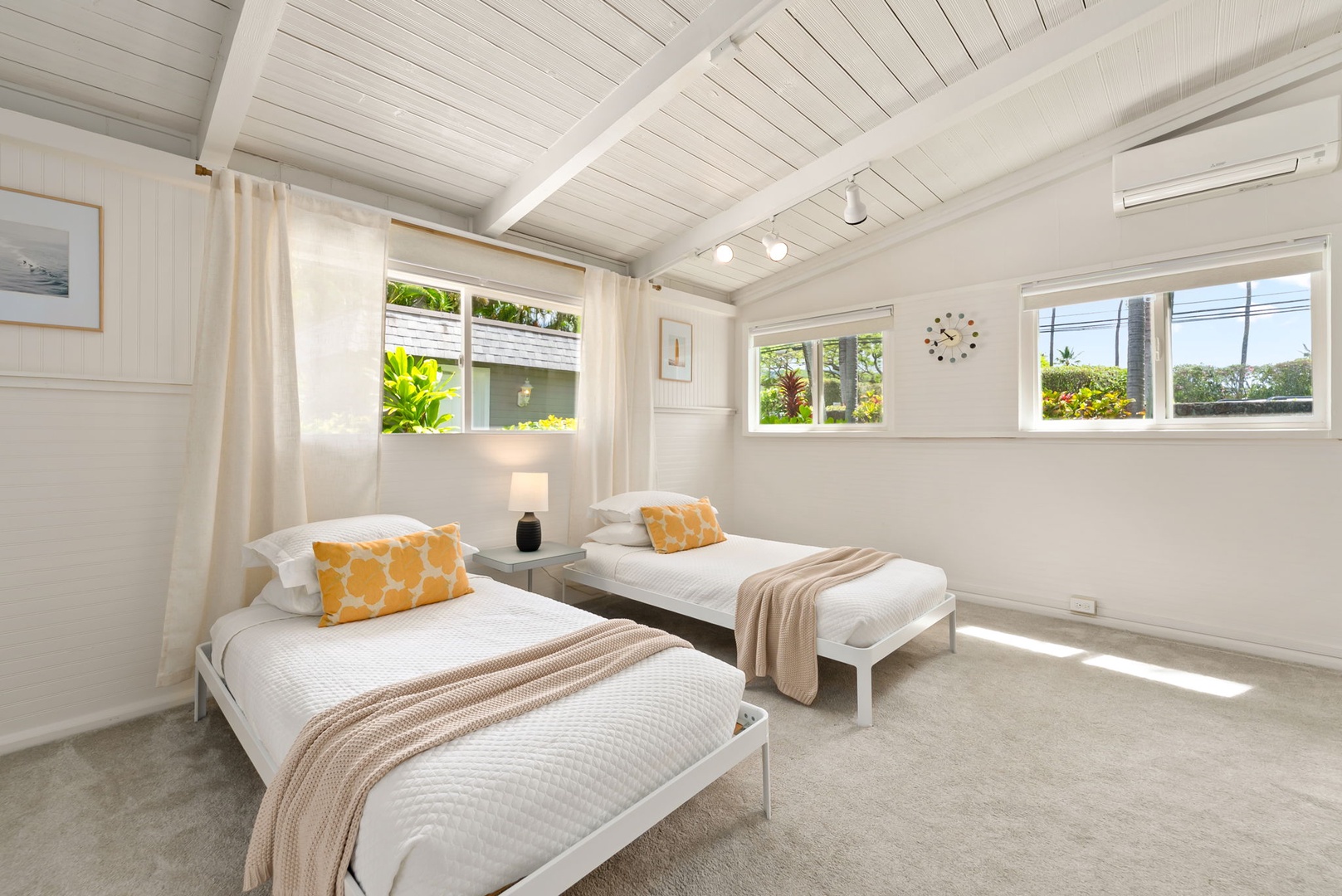 Honolulu Vacation Rentals, Ho'okipa Villa - Sunlight floods your peaceful retreat, where crisp white linens, warm accents, and tropical garden views create a serene haven for restful nights.