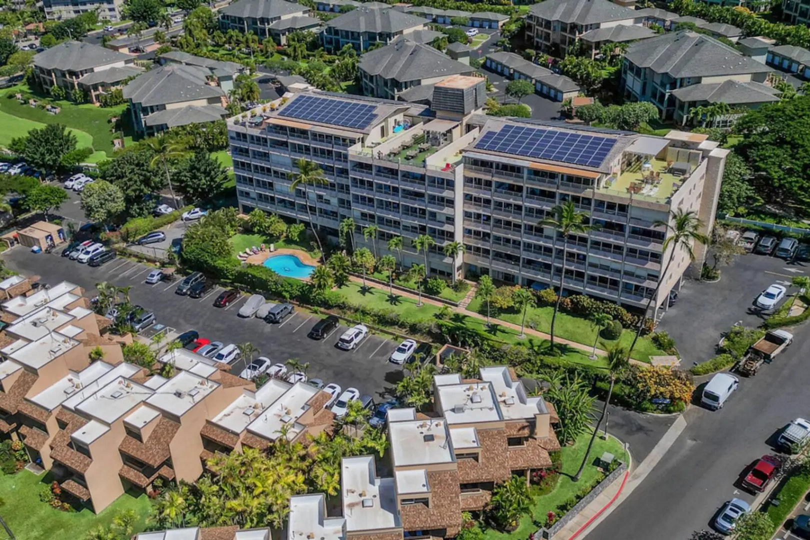 Kihei Vacation Rentals, Kamaole Beach Royal 610 - Solar panels, a pool, and a rooftop terrace crown the building.