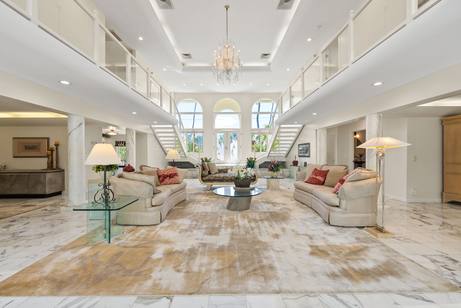 Honolulu Vacation Rentals, Kahala Oasis - Sophisticated living area with soaring ceilings and elegant furnishings, creating a luxurious yet cozy setting.