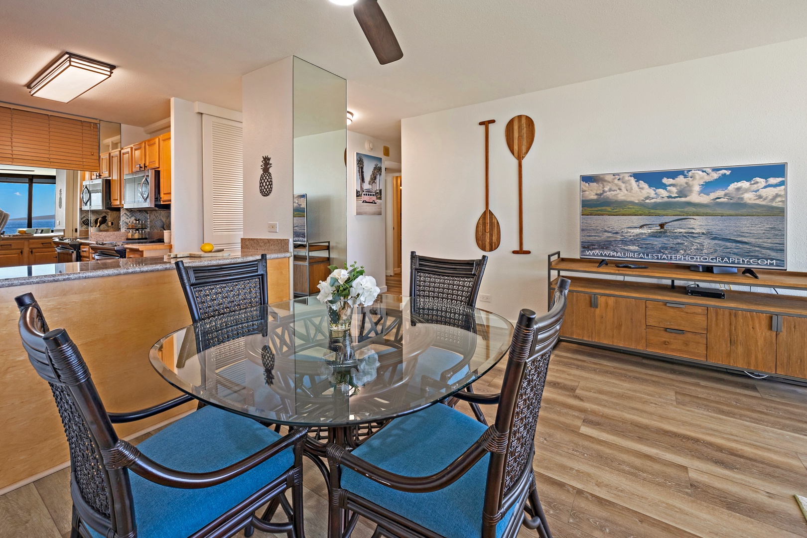 Lahaina Vacation Rentals, Mahana 718 - The dining area, adjacent to the open kitchen, provides a cozy spot for meals with views of the ocean, surrounded by island-inspired decor that adds a touch of tropical flair.