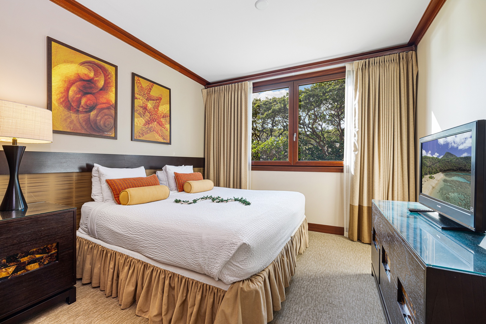 Your serene retreat features a plush bed dressed in crisp linens, warm wood accents, and garden views framed by elegant curtains. Entertainment awaits with a flat-screen TV.