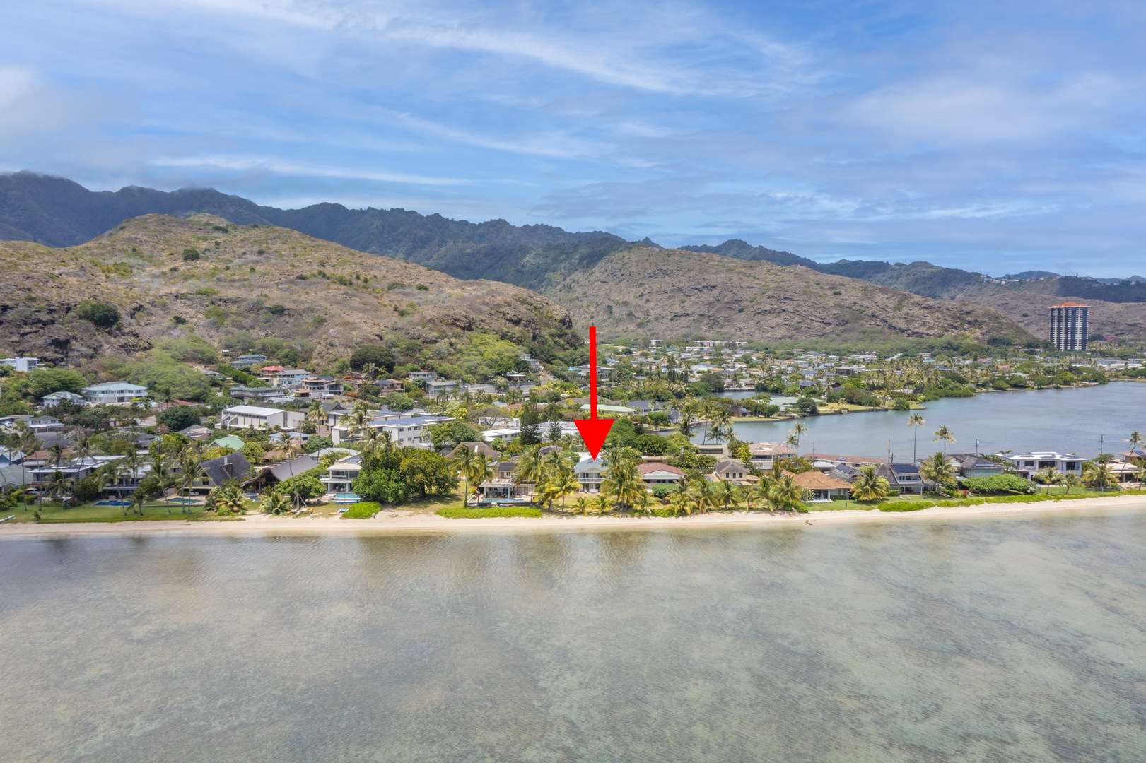 Honolulu Vacation Rentals, Honolulu Beachfront Retreat - Wide aerial shot with a marked property, featuring nearby mountains and the ocean.