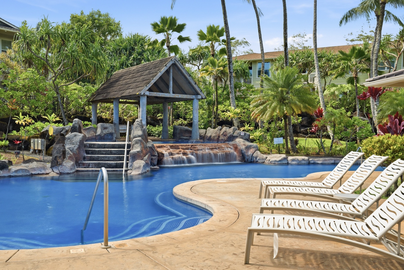 Princeville Vacation Rentals, Hale Kaua'i - Relax poolside beneath swaying palms and enjoy the peaceful North Shore atmosphere.