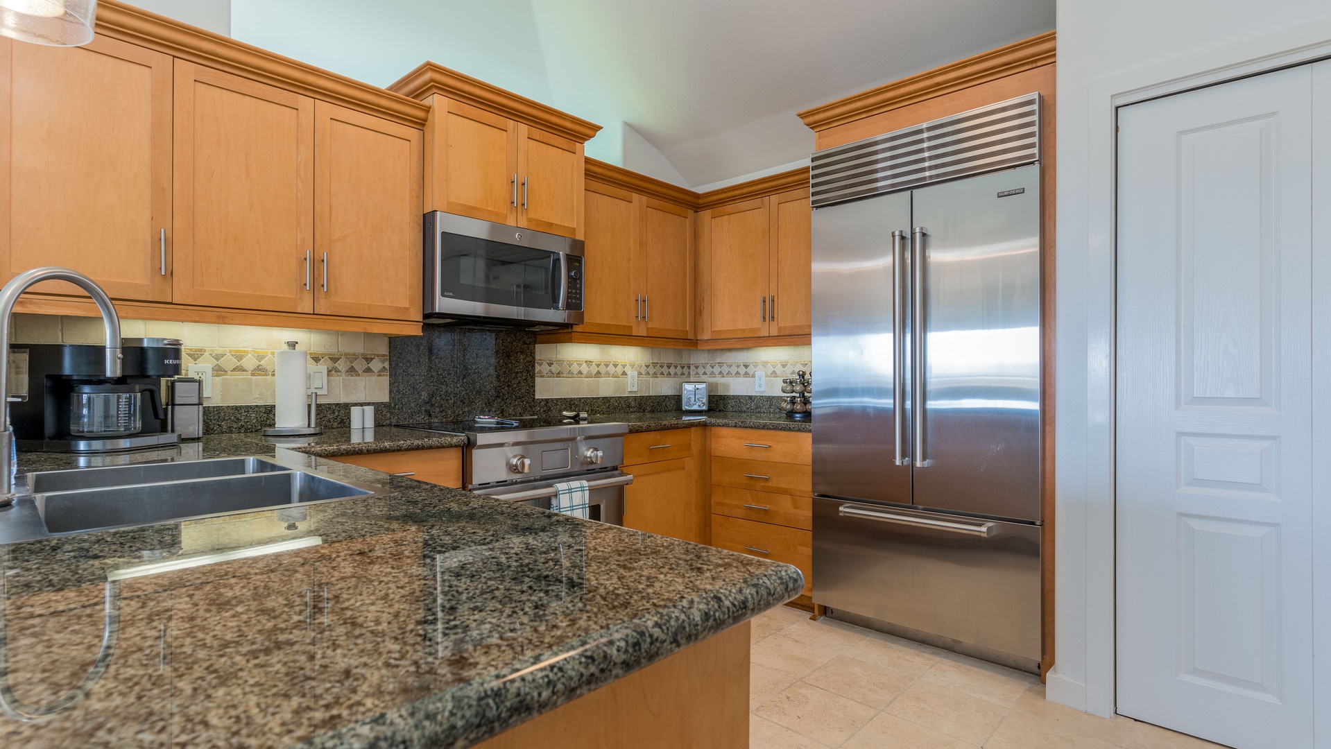 Kapolei Vacation Rentals, Kai Lani 21C - The kitchen features stainless steel appliances and high ceilings.