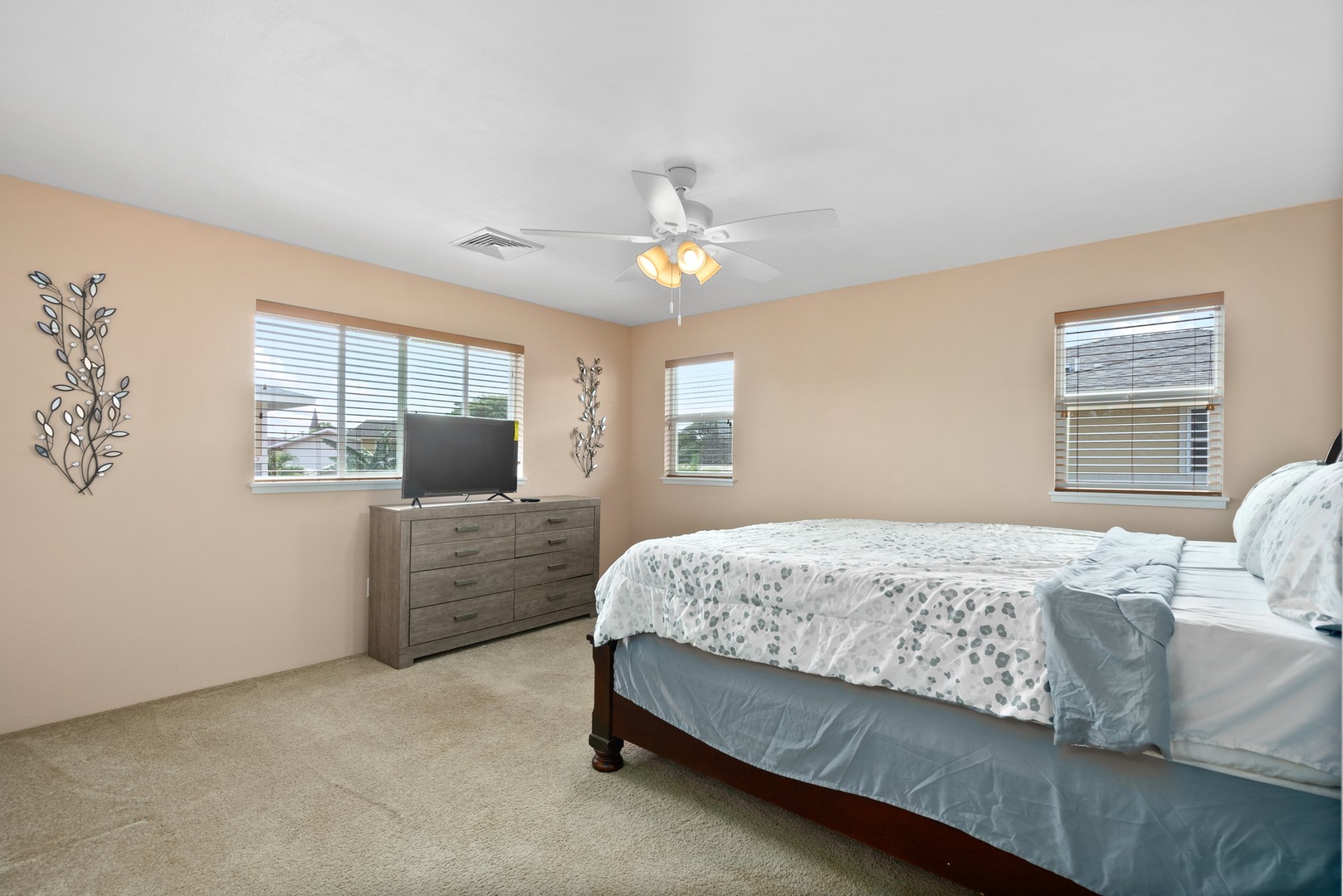 Kapolei Vacation Rentals, Kilipue Retreat - Comfortable primary bedroom with king bed and soft natural light for a restful night’s sleep.