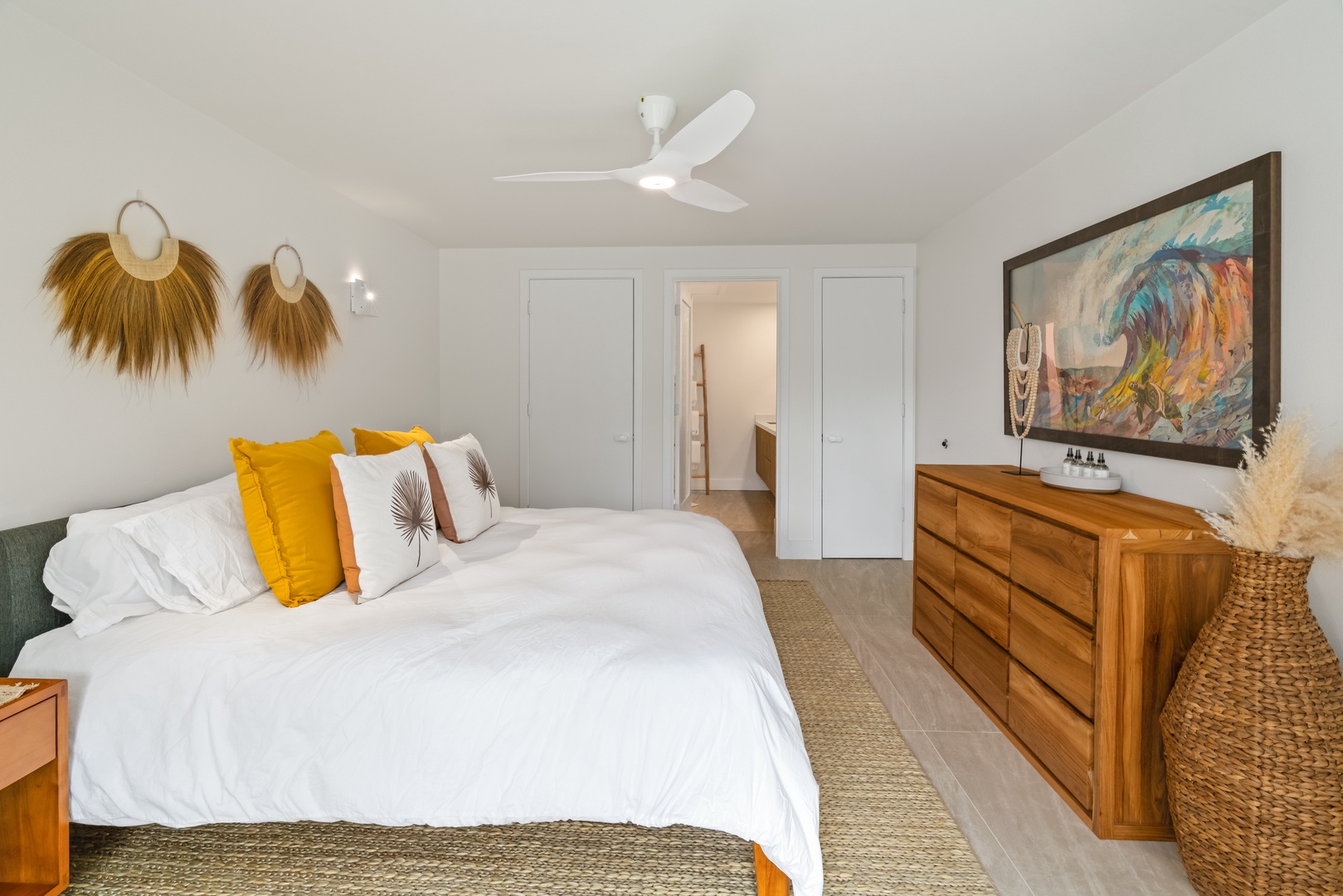 Princeville Vacation Rentals, Mana Wahine - Spacious primary suite with King bed and warm wood furnishings.