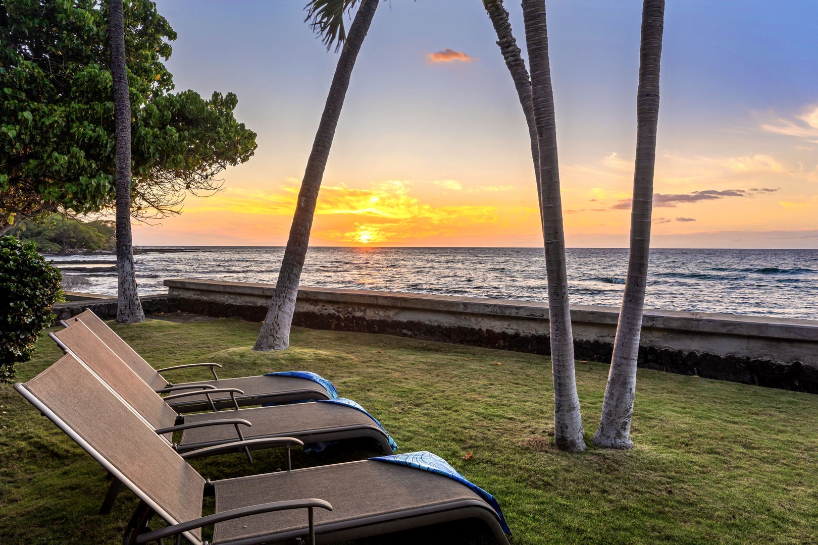 Kamuela Vacation Rentals, Island Time Retreat - Loungers under the palms, angled at the water for the last hour of light.