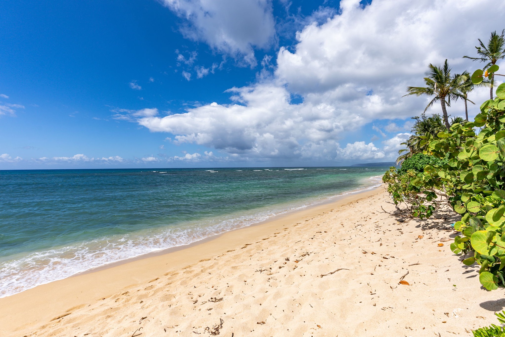 Waialua Vacation Rentals, Mokuleia Beach Villa** - Step right from your backyard onto the sandy shores of Mokuleia Beach, known for its calm waters and breathtaking sunsets.