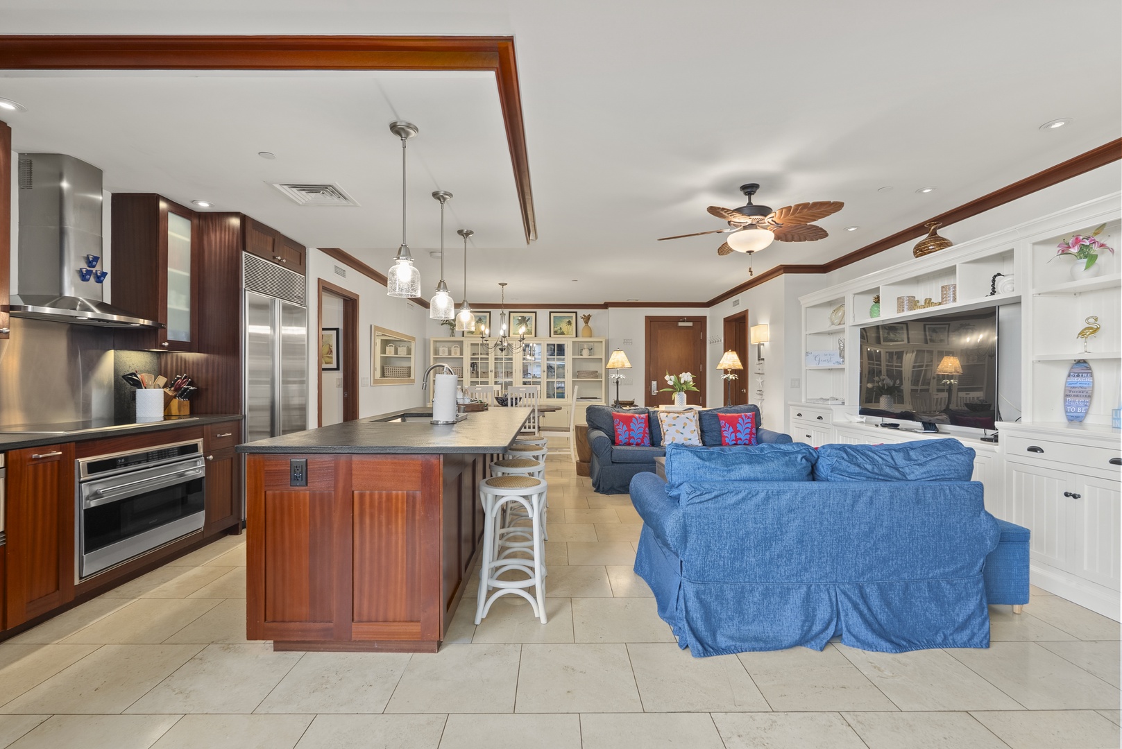 Pendant lights frame the island, where snacks, conversation, and dinner prep come together.