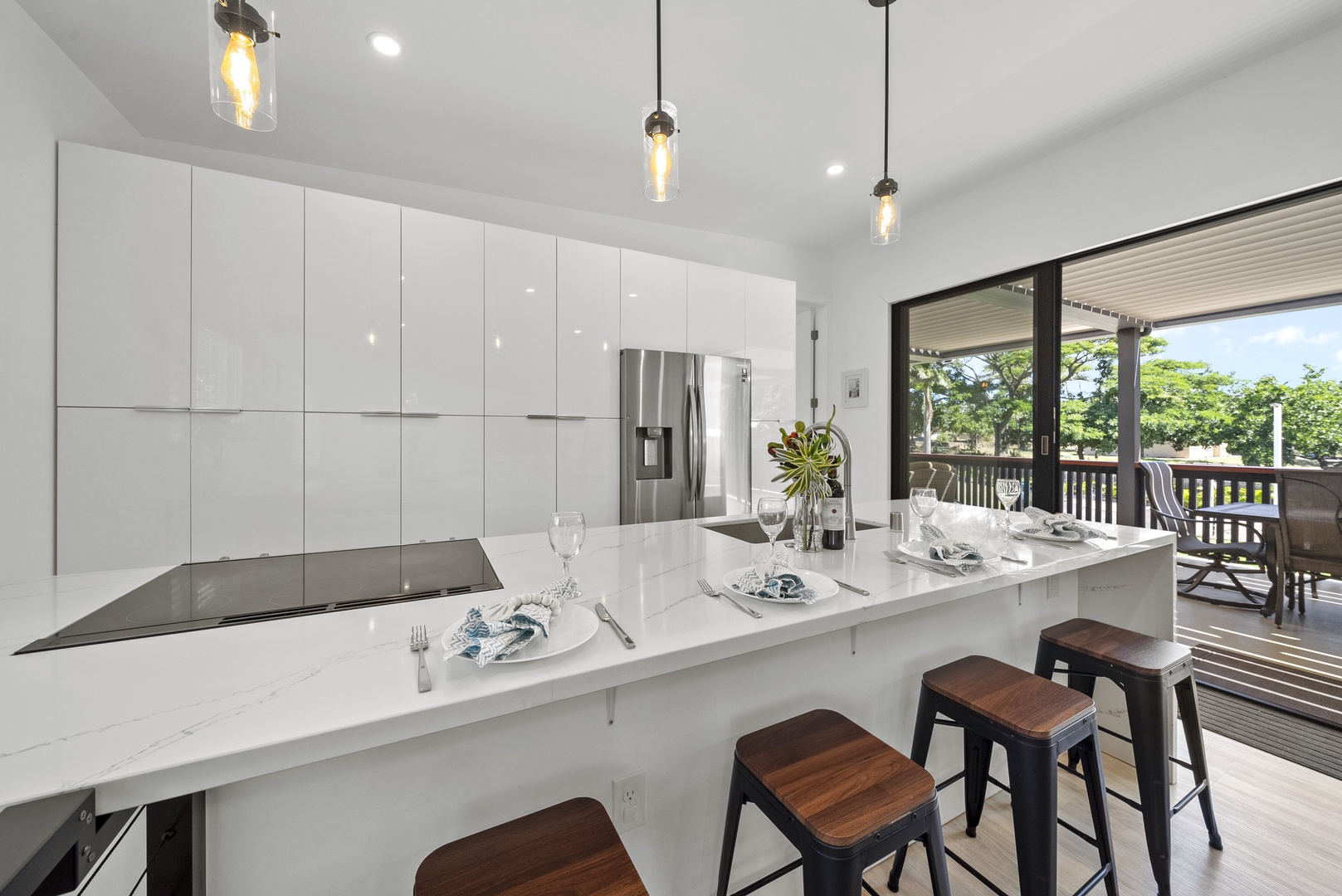 Haleiwa Vacation Rentals, Sunset Beach Island Retreat - The modern kitchen showcases a spacious island with seating for five, making it an ideal spot for casual dining or gathering