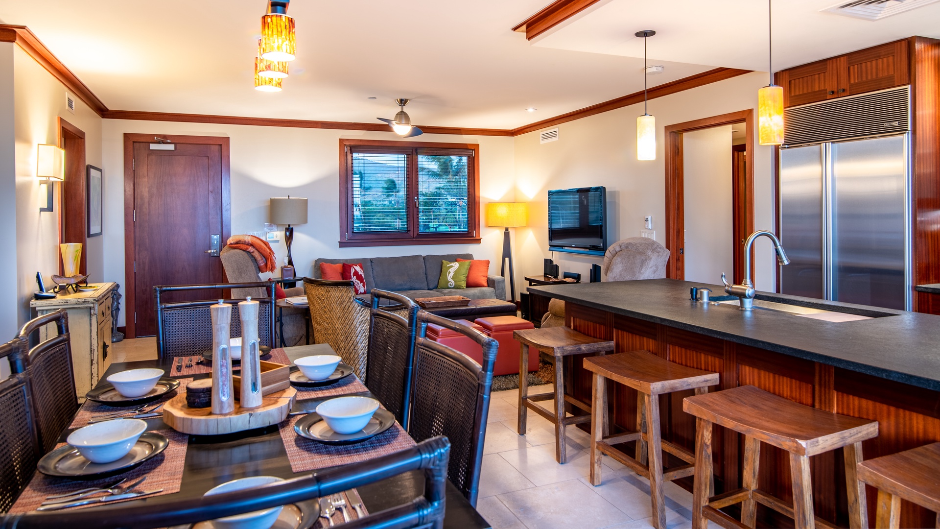 Kapolei Vacation Rentals, Ko Olina Beach Villas B301 - A Roy Yamaguci designed kitchen with stainless steel appliances and a cozy living room area.