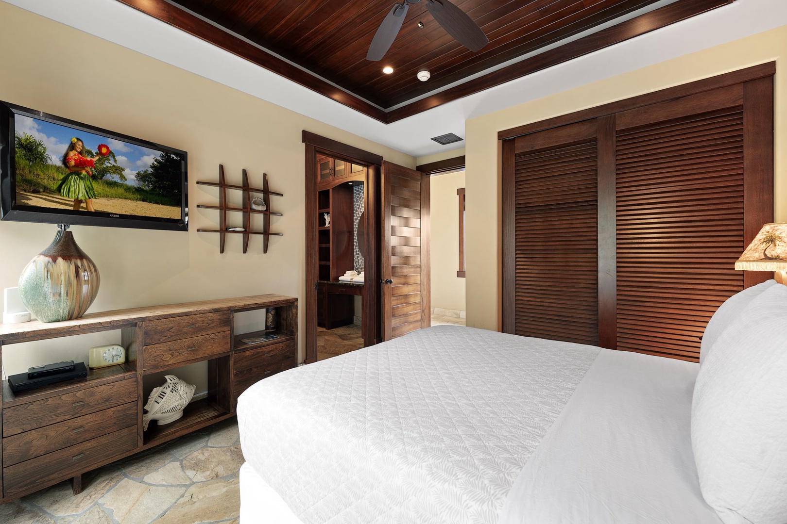 Kamuela Vacation Rentals, Hale Konane - Elegant guest suite with warm wood accents and soft lighting for a restful, island-inspired night.