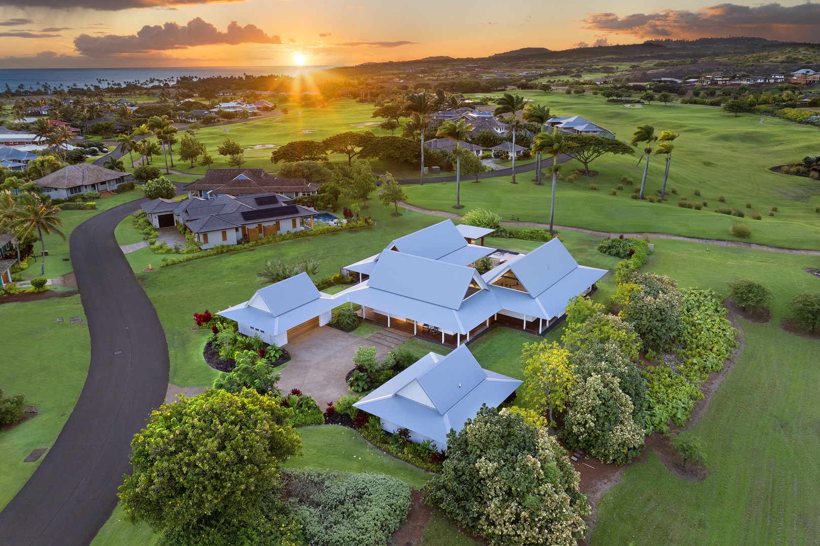 Koloa Vacation Rentals, Kaulu Hale at Kukuiula - Expansive retreat with lush greenery and sunset views over the horizon.