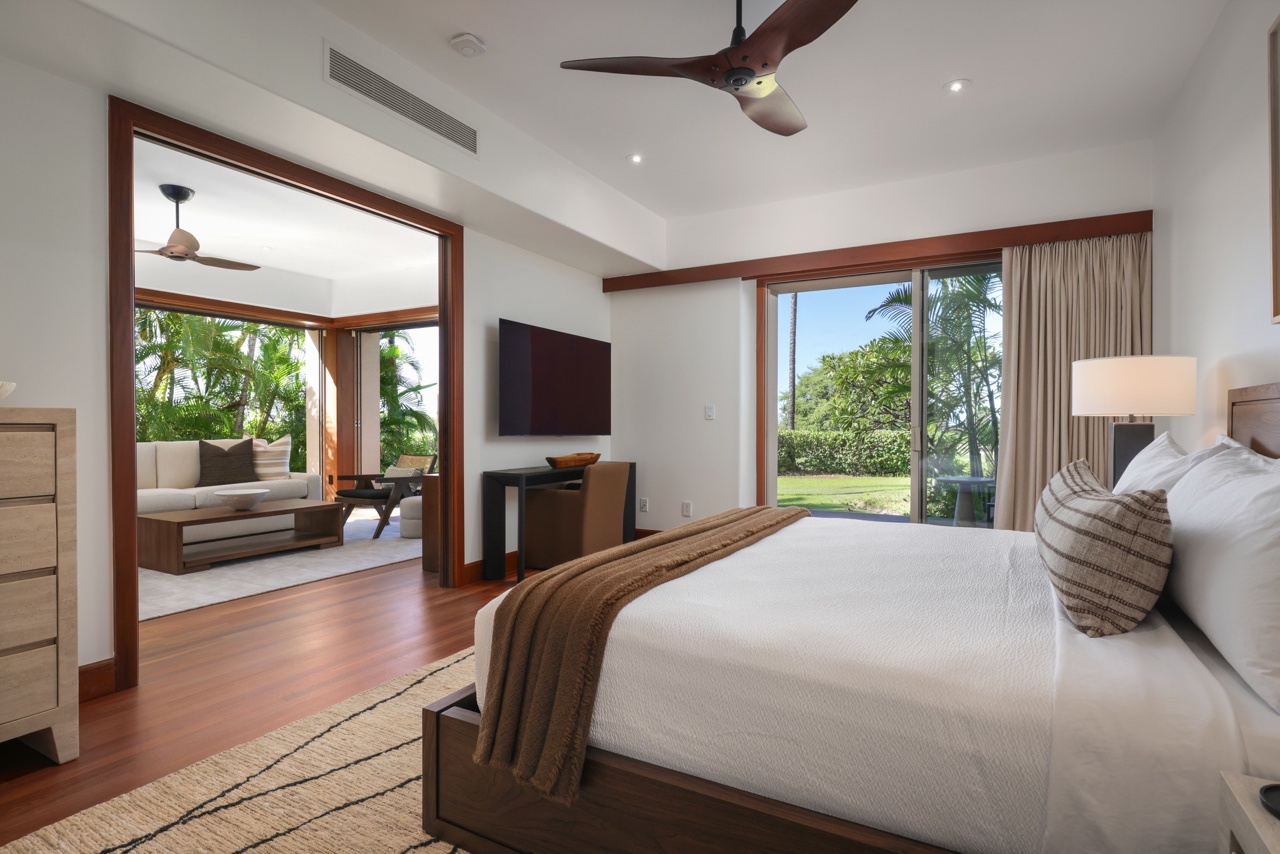 Kailua Kona Vacation Rentals, 3BD Ka'Ulu Villa (109A) at Hualalai Resort - Primary bedroom suite (lower level) with king bed, lanai access, 65” smart television, walk-in closet & en suite bath.