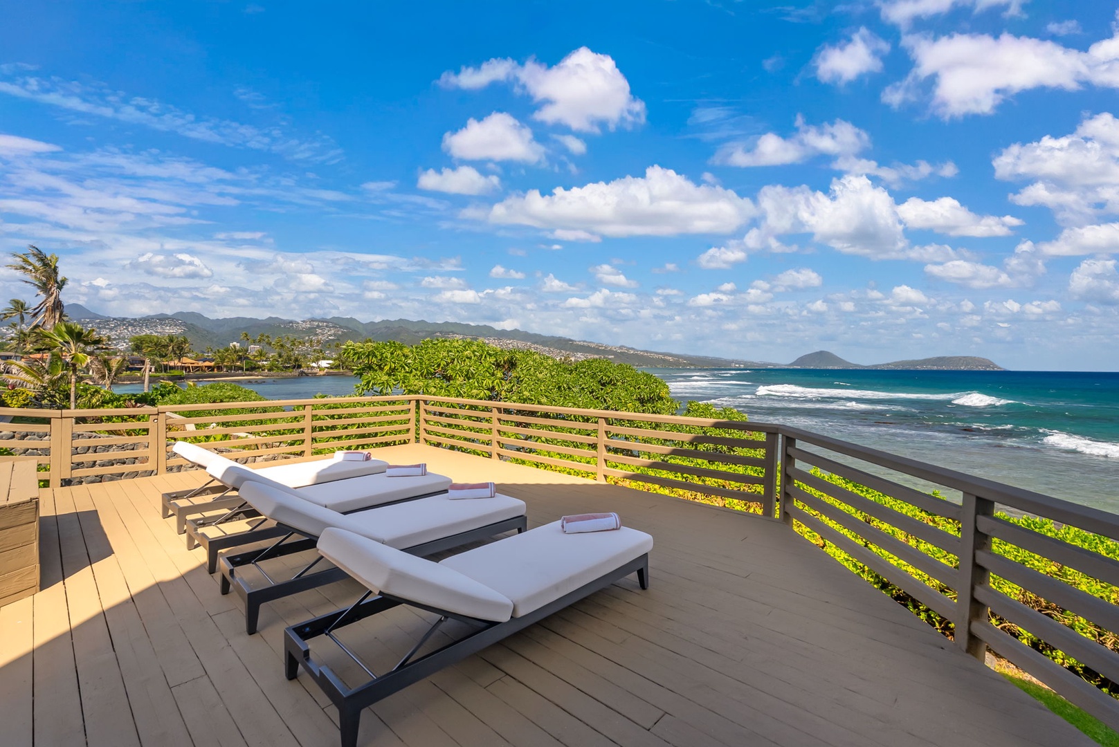 Honolulu Vacation Rentals, Black Point Ocean Villa - Soak up the sun on your private lanai with plush loungers overlooking pristine turquoise waters and rolling hills.