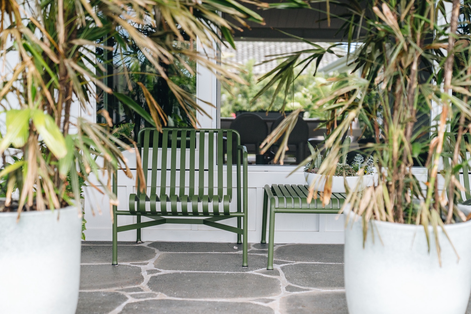 Honolulu Vacation Rentals, Surfside Bungalow** - A quiet outdoor nook surrounded by lush landscaping, perfect for morning coffee or evening relaxation.