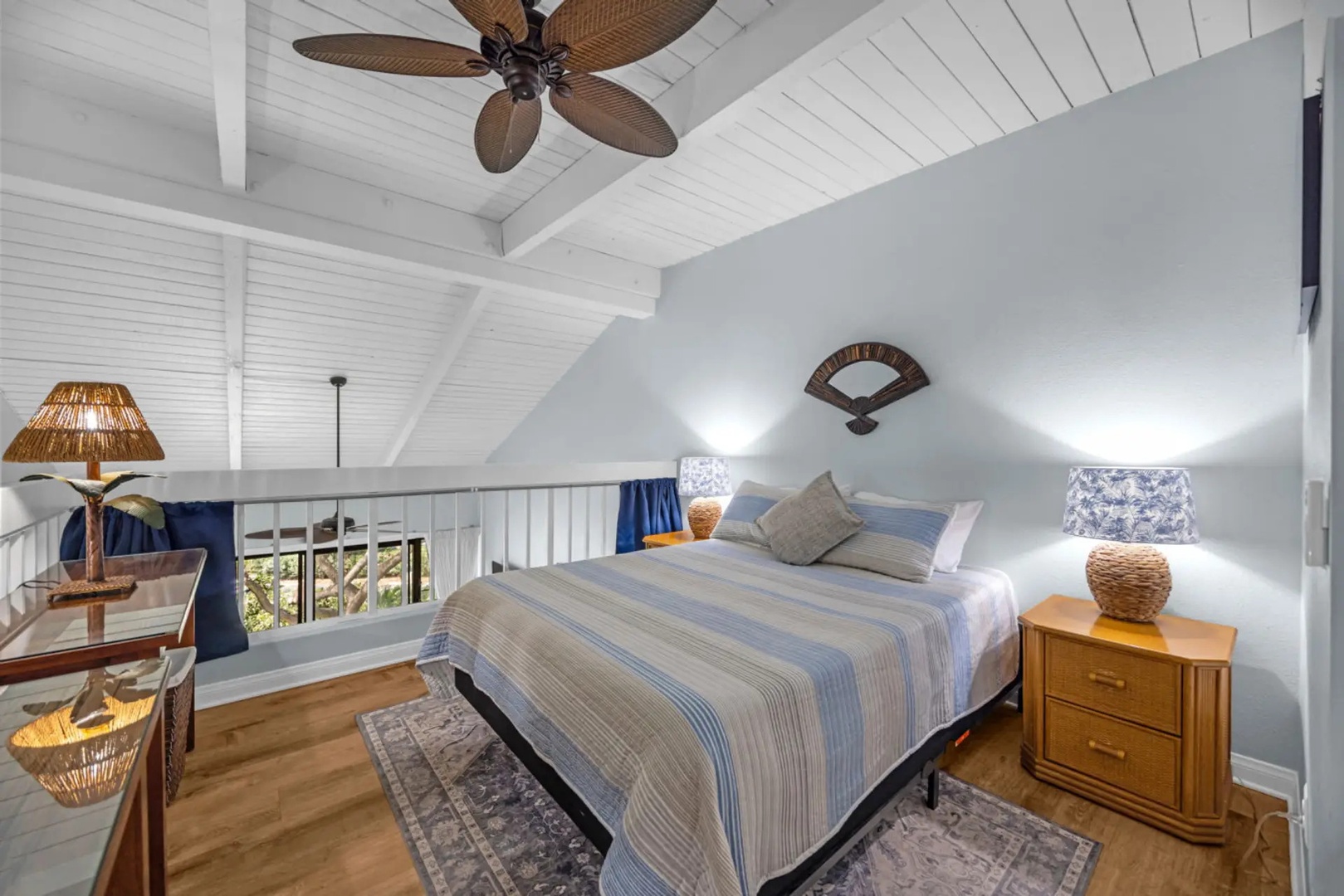 Kihei Vacation Rentals, Maui Vista 2420 - Up in the loft, a pitched plank ceiling slopes over the bed, one level above the living space.