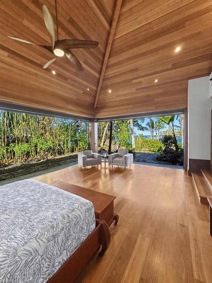 Kailua-Kona Vacation Rentals, Hahalua Bay Villa - Wake to lush tropical views in your elegant bedroom, where warm wood and cooling fans create your perfect island sanctuary.