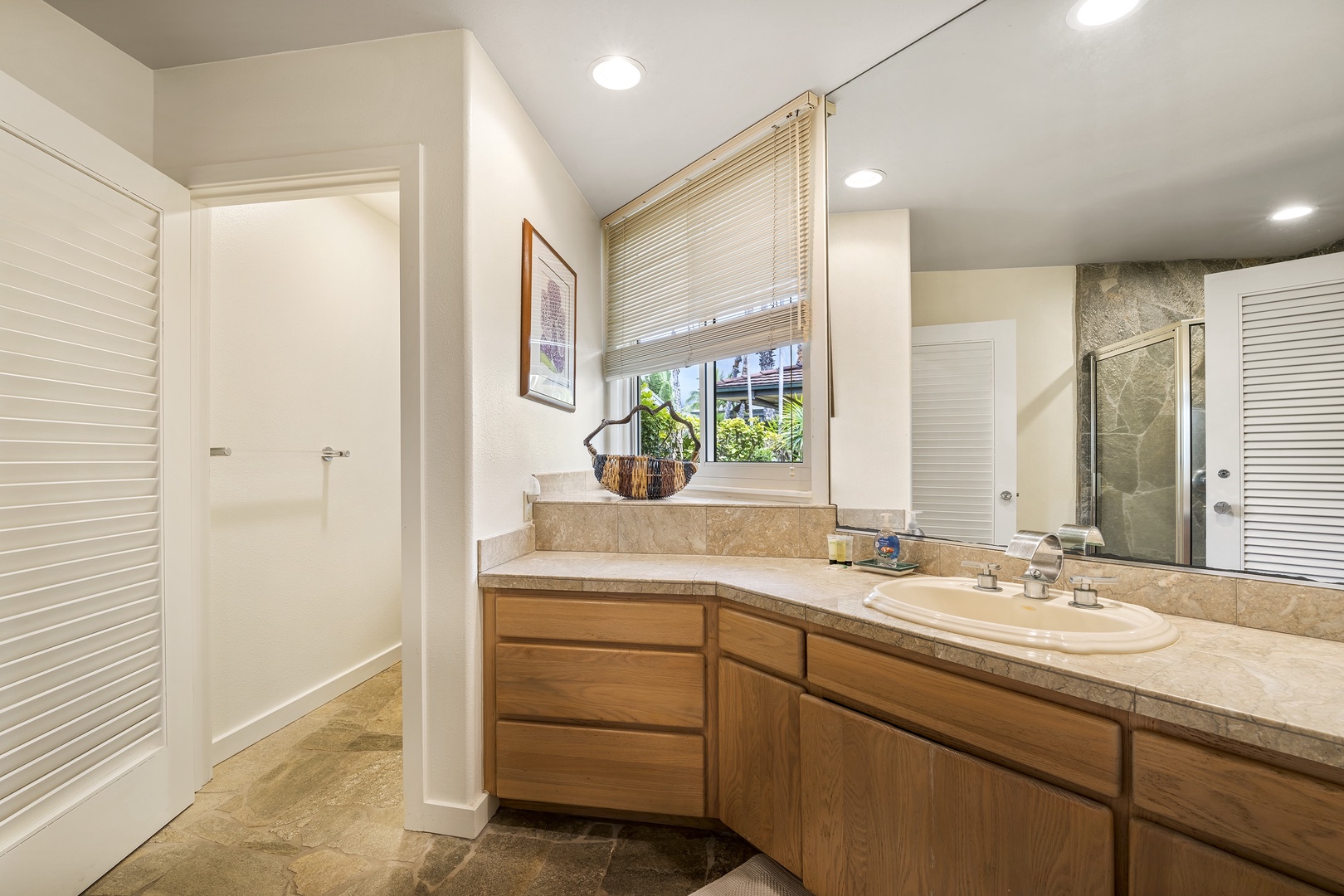 Kailua Kona Vacation Rentals, Ali'i Point #12 - Full guest bathroom down the hall with dual vanity and bright lighting—perfect for shared use.