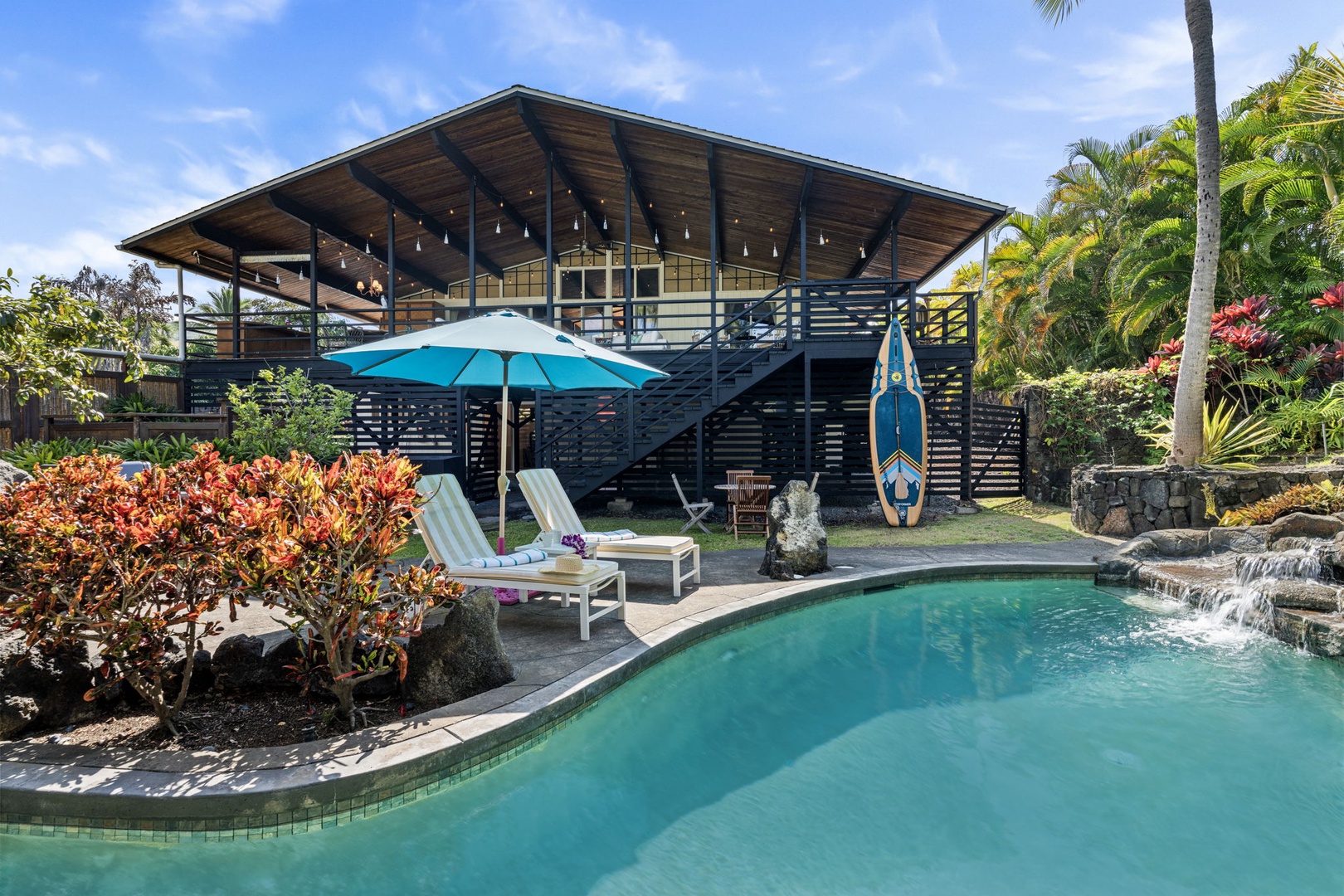 Kailua Kona Vacation Rentals, Mai Tai Manor - Modern tropical home with private pool, lush gardens, and outdoor entertaining spaces surrounded by palm trees and vibrant landscaping.