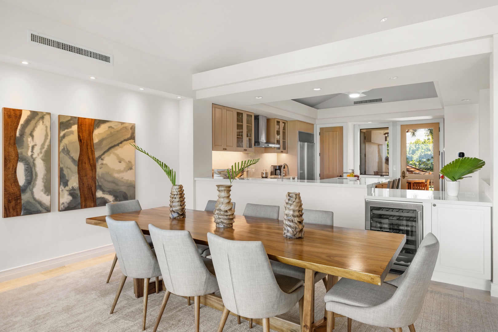 Kailua Kona Vacation Rentals, 3BD Palm Villa (130B) at Hualalai Resort - Gather around this stunning dining table where warm wood meets modern elegance. The open kitchen flows seamlessly into your dining space, perfect for memorable meals.