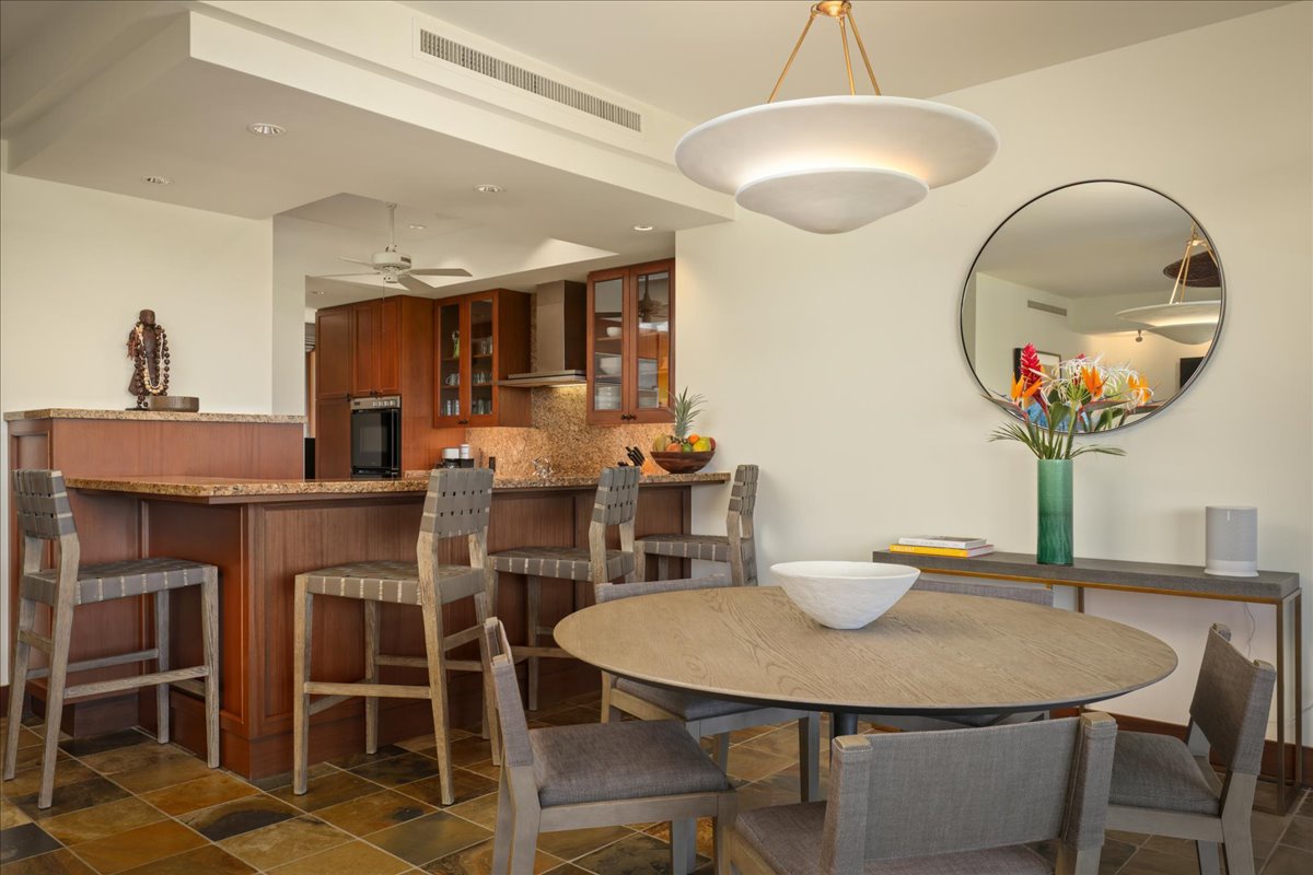 Kailua Kona Vacation Rentals, 2BD Fairways Villa (120C) at Four Seasons Resort at Hualalai - Elegant interior dining table and bar seating toward kitchen.