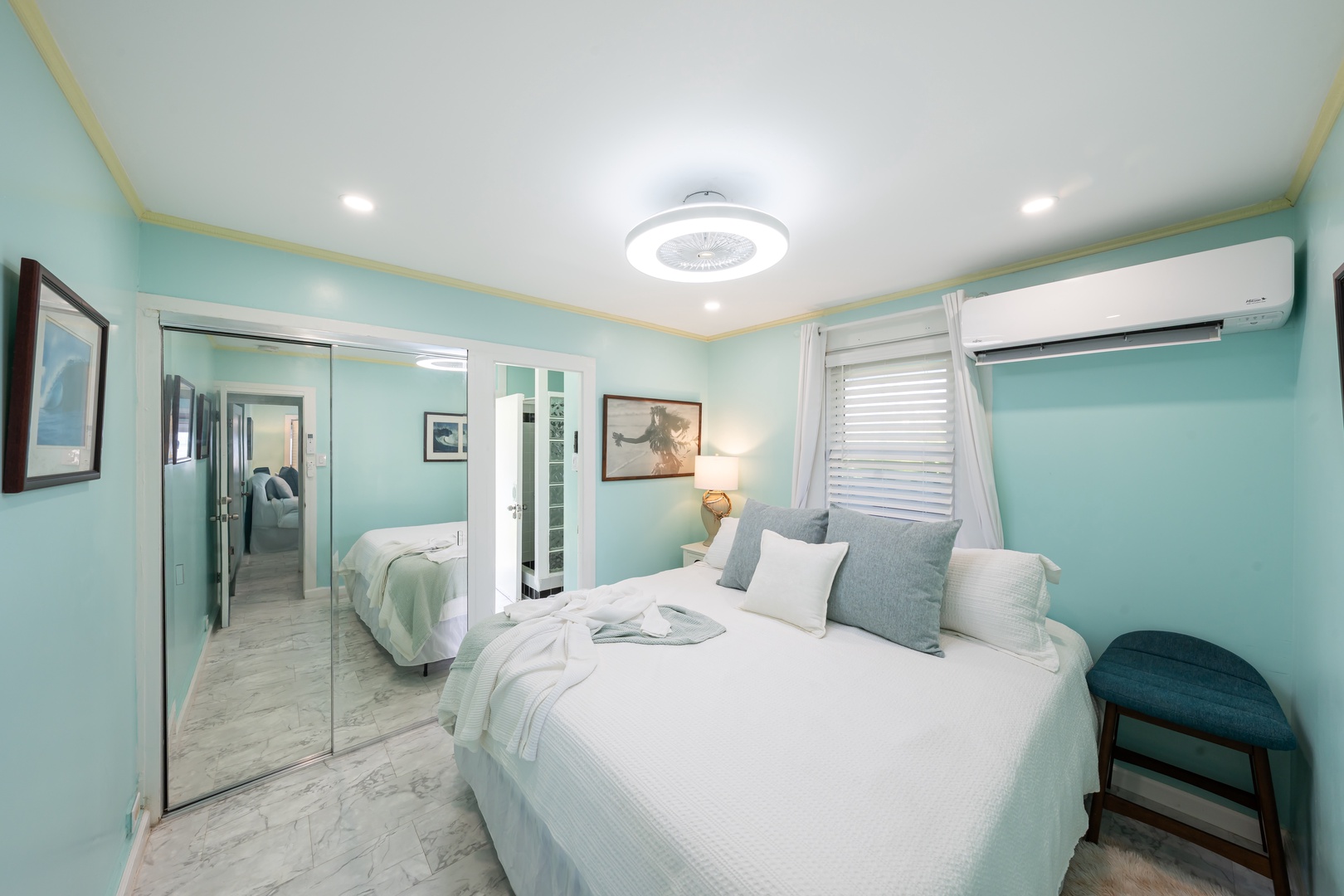 Hauula Vacation Rentals, Private Beach Paradise - Mirrored closets keep this bedroom bright and open, bed dressed in white.